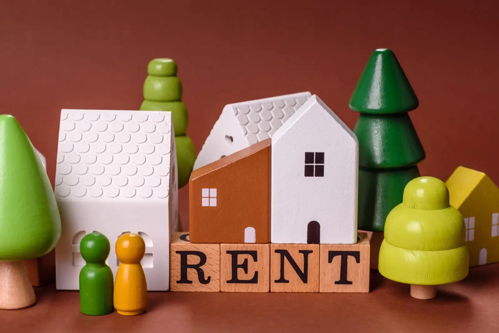 Toy houses with blocks spelling RENT
