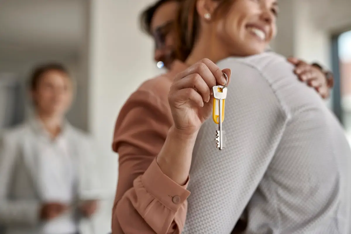 A couple holding the keys to their new home
