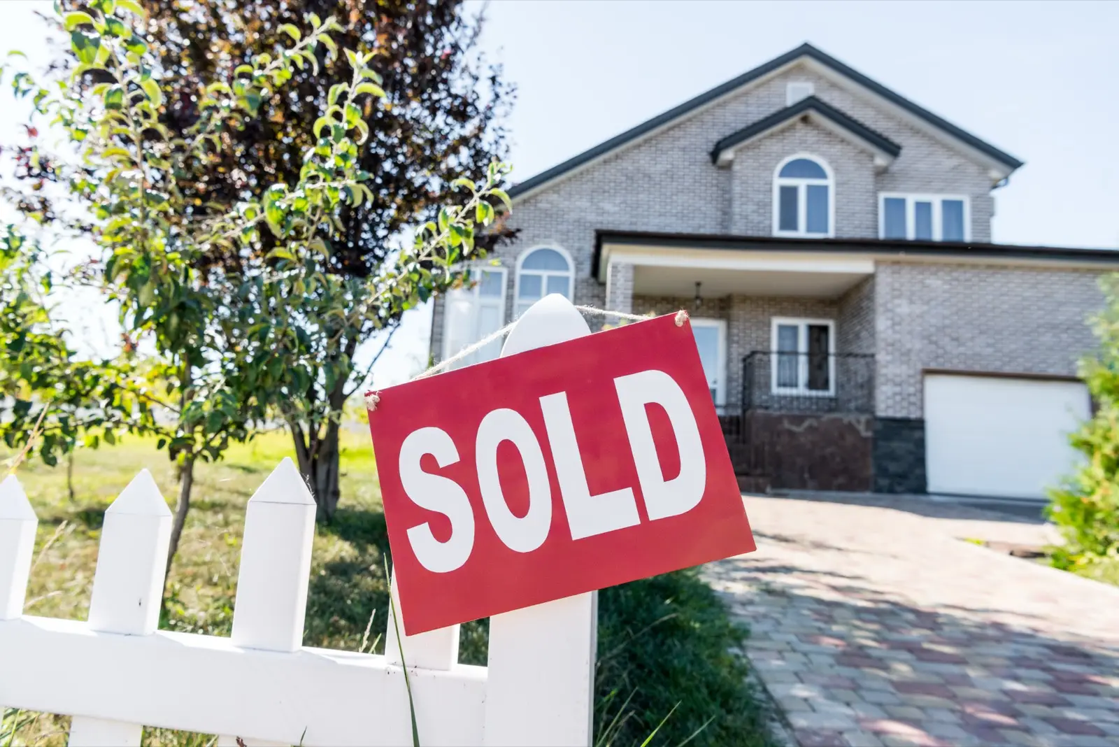A house with a Sold sign